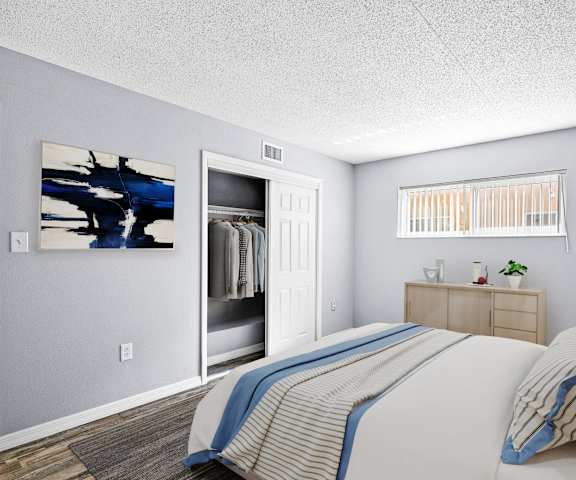 A bedroom with a bed, nightstand, and a painting on the wall.