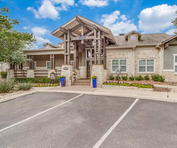 a large house with a parking lot in front of it