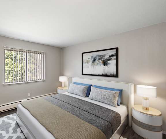 A bedroom with a large bed and two framed pictures on the wall.