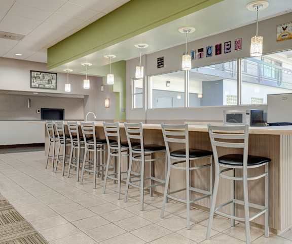 a bar with stools at a counter in a lobby