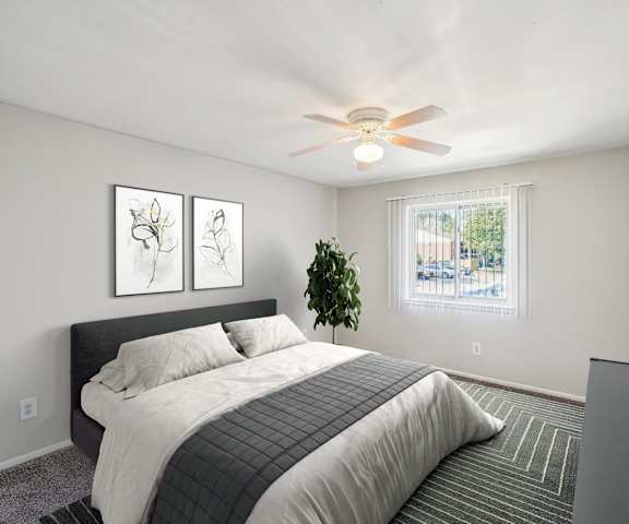 a bedroom with a bed and a ceiling fan