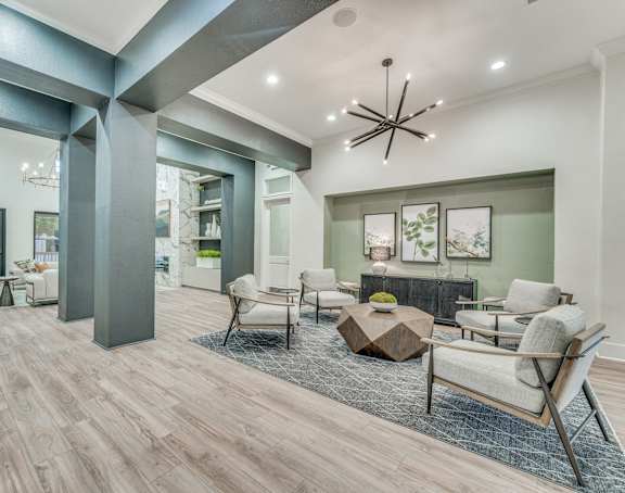a living room with furniture and a chandelier