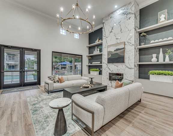 a living room with couches and a coffee table and a fireplace