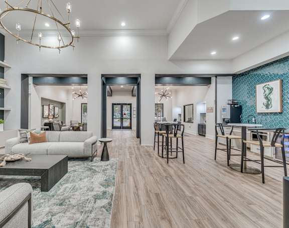 a living room and dining room with furniture and a chandelier