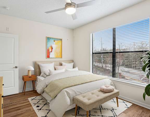A bedroom with a large bed and a painting on the wall.
