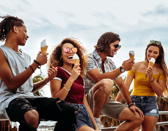 a group of young people eating ice cream
