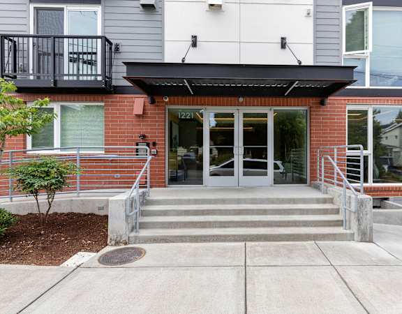 a view of the front of the building with a ramp leading up to the door at Arabella Apartment Homes in Shoreline, WA