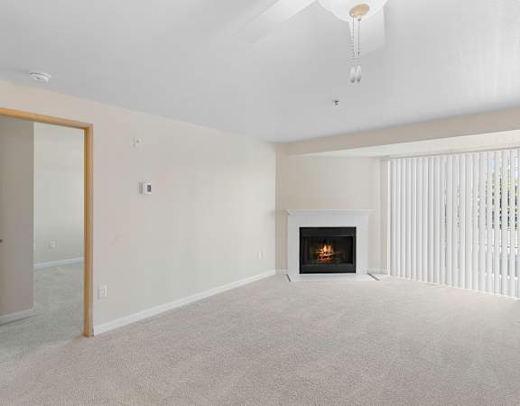 a bedroom with a fireplace and a mirror  at Casa Blanca Apartment Homes, Washington