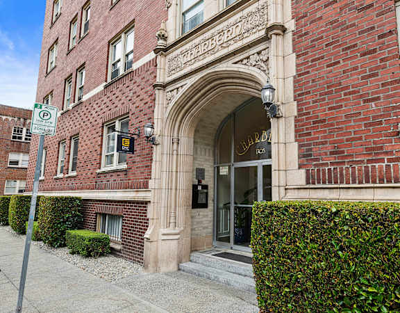 a brick building with an arched doorway  at Charbern Apartment Homes, Seattle, WA, 98122