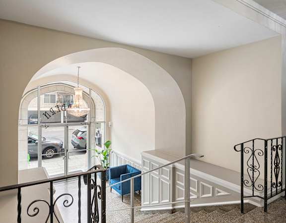 the view from the top of the stairs of a building with a window and stairs at Charbern Apartment Homes, Seattle, WA