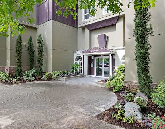 a picture of a building with a driveway in front of it at Excalibur, Bellevue, WA