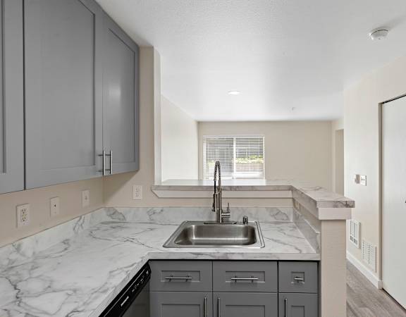 a kitchen with a sink and a window at Excalibur, Bellevue