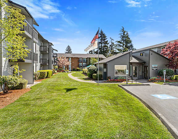 the preserve at cardinal woods exterior view of apartment buildings with lawn and trees at Pacific Park Apartment Homes, Edmonds, Washington 98026