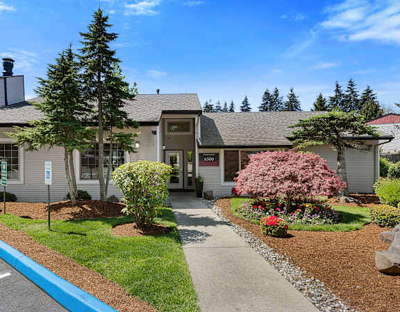 a small gray house with a sidewalk in front of it at Pinewood Square Apartment Homes, Washington, 98087