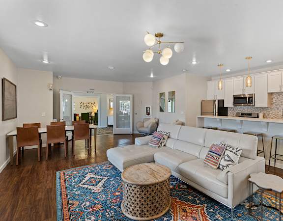 a living room with a white couch and a blue rug at Serra Vista Apartment Homes, Washington, 98087