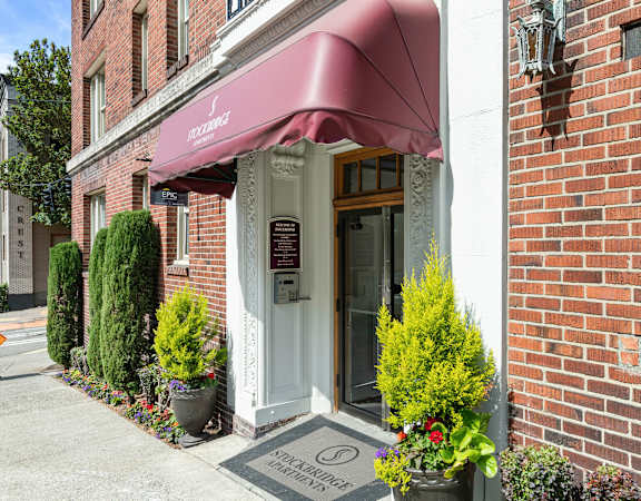 A brick building with a red awning and a sign that says at Stockbridge Apartment Homes, Seattle, 98101
