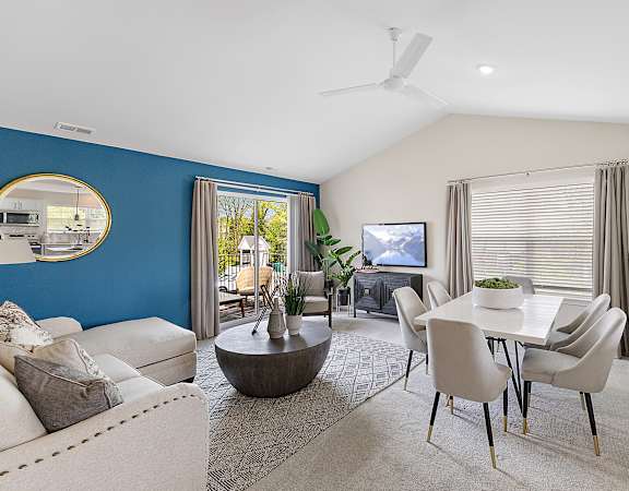 A living room with a blue wall and a television.