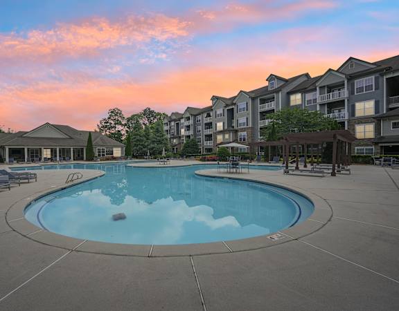 A large swimming pool surrounded by apartment buildings.