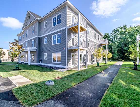 Modern apartment building exterior with balconies at Windham Village Apartments, Windham, ME 04062