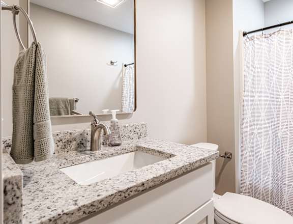 Bathroom with granite countertop and modern fixtures at Windham Village Apartments, Windham, ME 04062