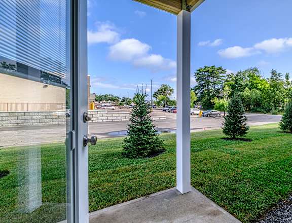 Open patio doors with lawn and parking view at Windham Village Apartments, Windham, ME