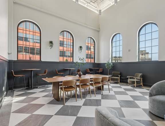 A large room with a checkered floor and a long table with chairs. at LiveWell Apartments, Pittsburgh, PA, 15222