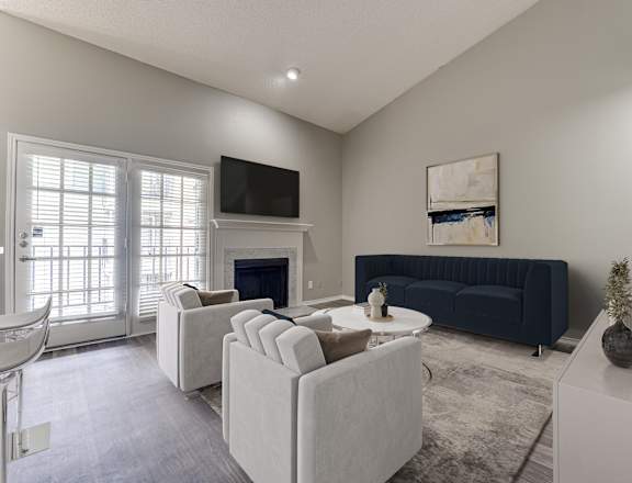 A living room with a fireplace and a television.