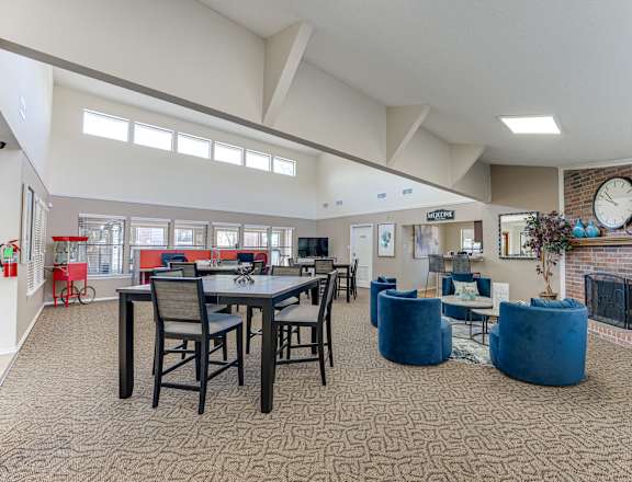 A large open living room with a dining table and chairs.