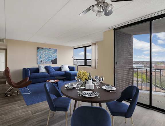 A dining room with a table set for two and a view of the outside.