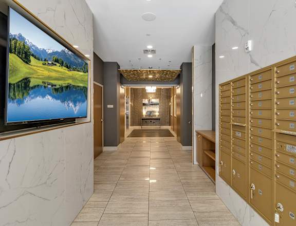 a view of a hallway with mailboxes and a television on the wall  at Nineteen North, Buffalo, New York 14202