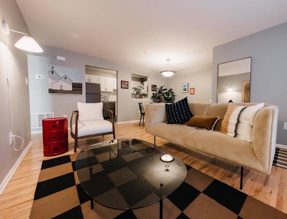 a living room with a checkered rug and a couch