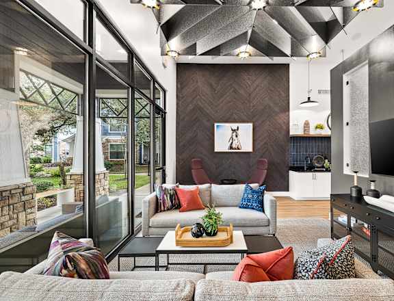 A modern living room with a grey couch and a wooden coffee table.