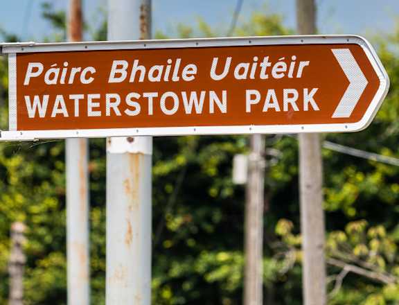 a sign points the way to watertown park