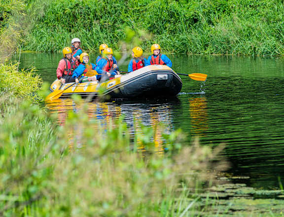 a group of people in a boat on a river