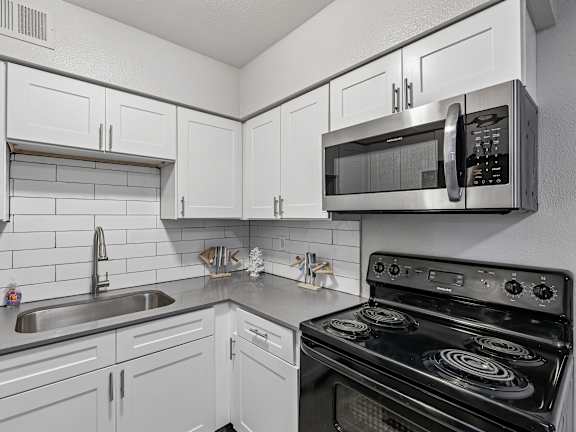 Modern kitchen with white subway tile backsplash1 at Zoom Apartments, Las Vegas, NV