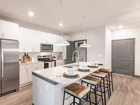 a kitchen with stainless steel appliances and granite counter tops at The Beck at Hidden River, Tampa, FL, Florida