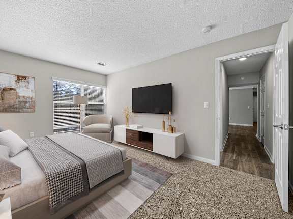 A bedroom with a large bed and a television.