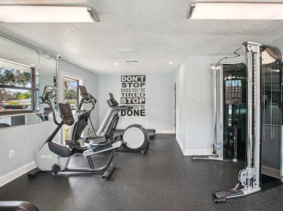 A gym with a sign that says "Don't stop when you're tired, stop when you're done."