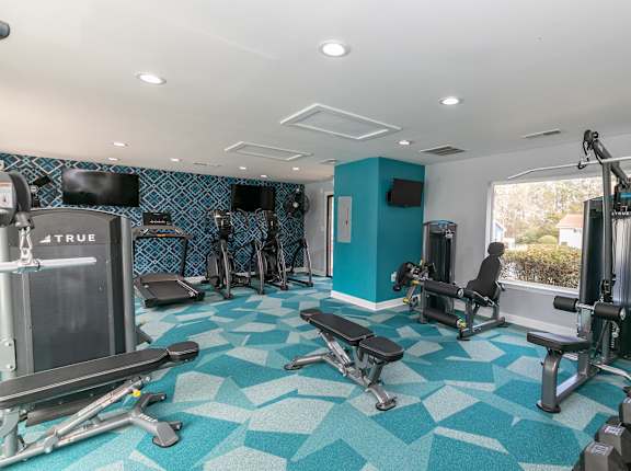 a gym with exercise equipment and a window