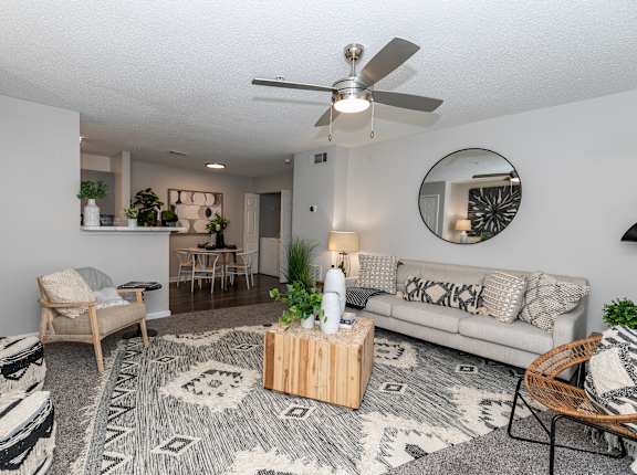 a living room with a couch and a ceiling fan