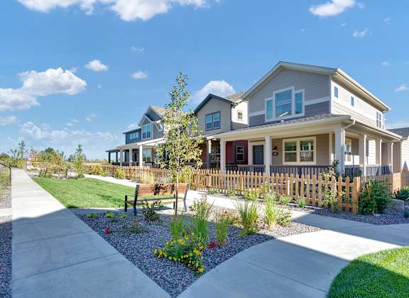 a house with a yard and a sidewalk in front of it