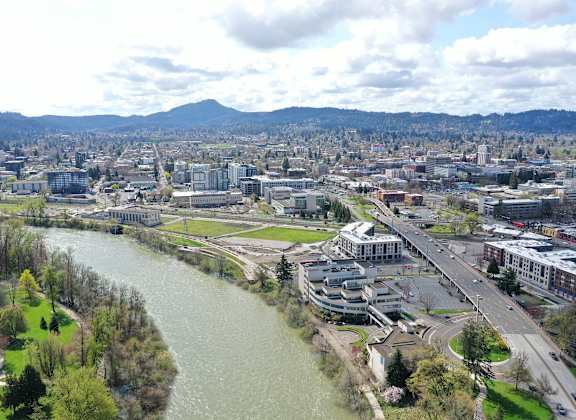A river flows through a city with a bridge crossing it.