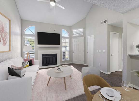 a living room with white furniture and a fireplace