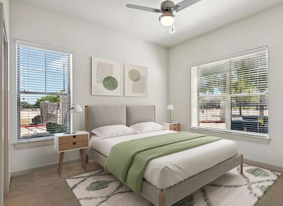a bedroom with a bed and two windows