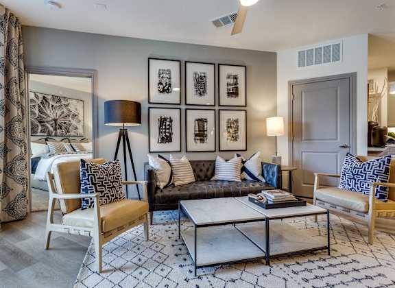 a living room with a couch and chairs and a coffee table