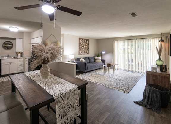 an open living room with a dining room table and a kitchen