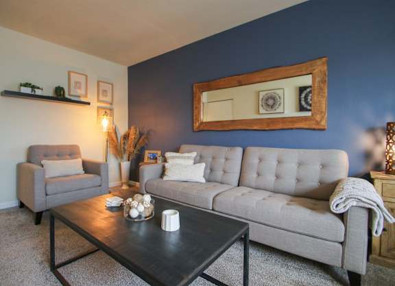 a living room with blue walls and a couch and a coffee table