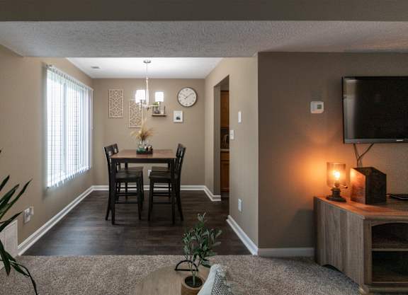 an open living room and dining room with a table and chairs