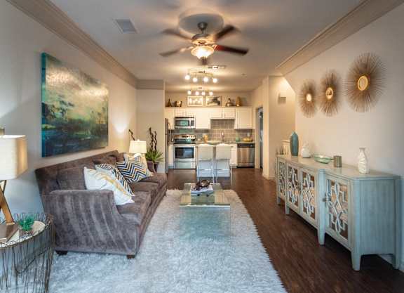 a living room with a couch and a ceiling fan