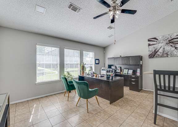 Leasing office exterior with desks and seating at Arbors Of Cleburne, Cleburne, 76033